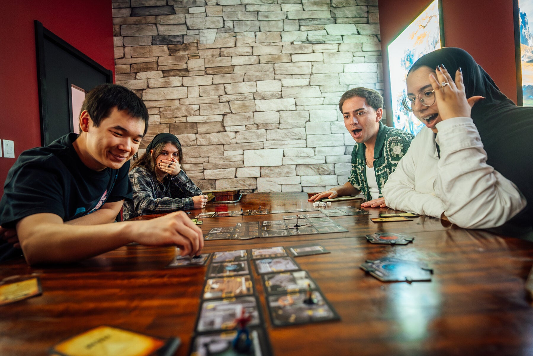 Friends enjoying board games at Invictus